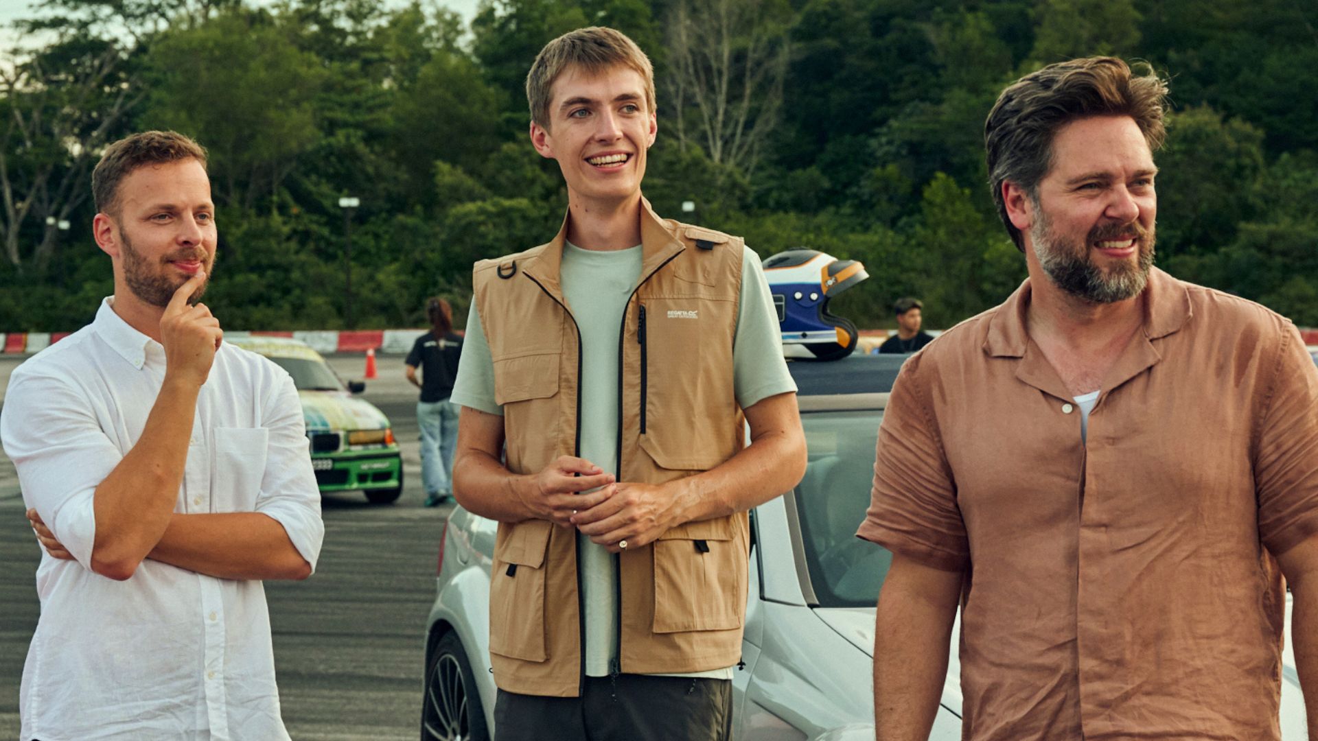 James, Francis and Thomas look at something on a racetrack