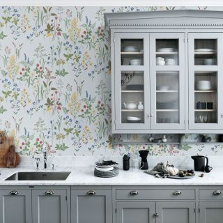 Floral wallpaper in a grey kitchen by Sandberg with chrome detail