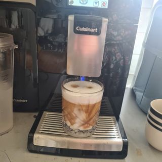 Cuisinart Veloce coffee machine with glass cup full of coffee