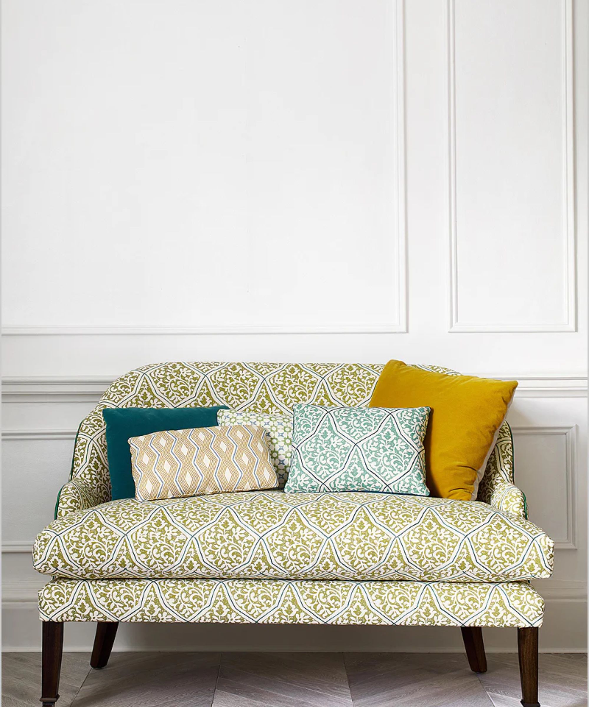 Colourful patterned green sofa with scatter cushions