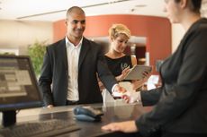 Business person checking into hotel lobby