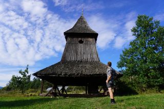 Image shows Stefan looking at the bell tower in the Museum of the Slovak Village