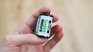 Ilford HP5 Plus 35mm film canister held in a hand