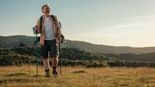 Man walking in green landscape