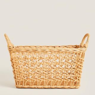A handled woven rattan basket that's a part of Zara Home's summer sale.