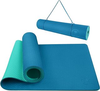 A bright blue and turquoise yoga mat with a carrying strap