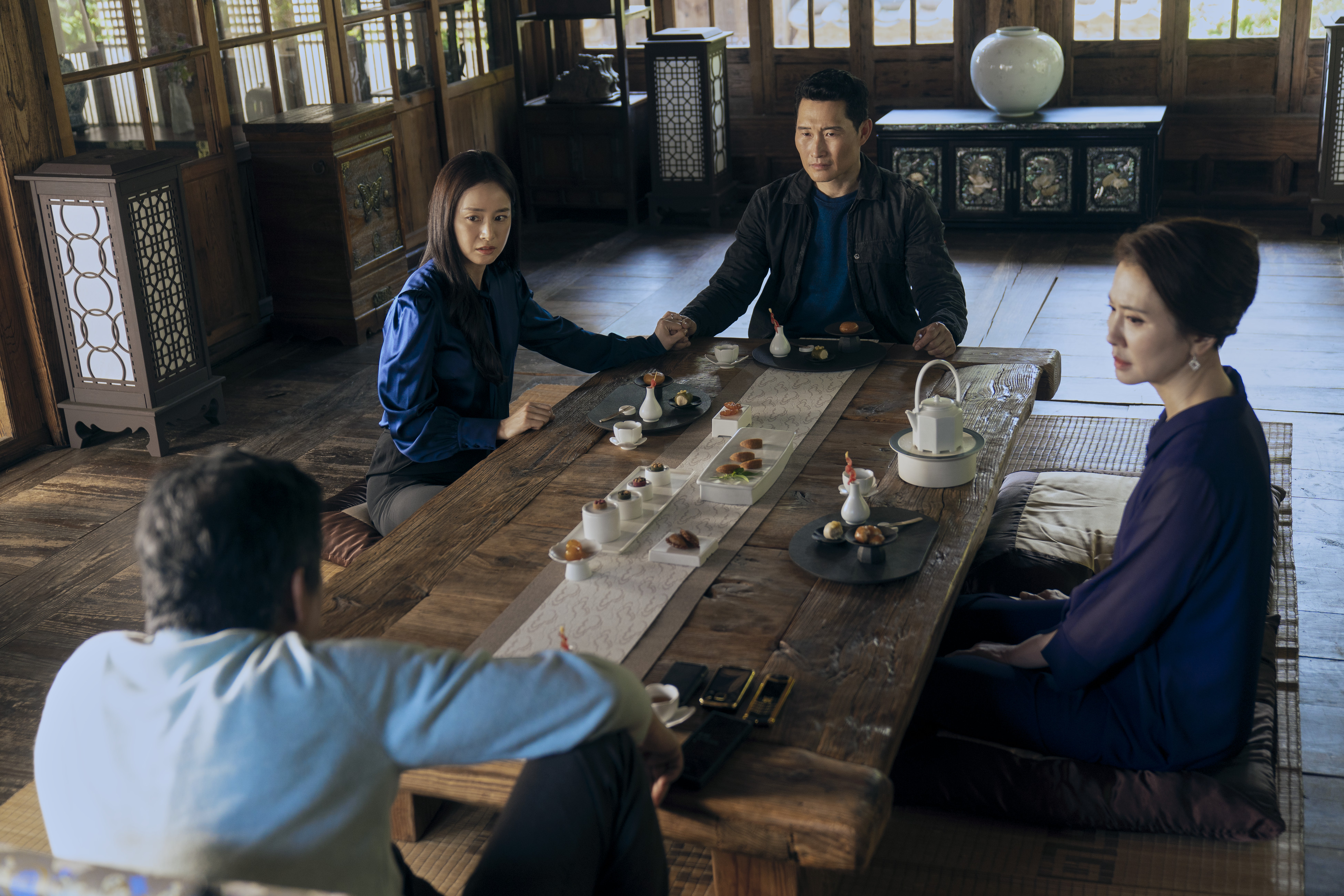 A family (l-r Kim Tae-hee, Daniel Dae Kim, Lee Il-hwa, Sung Dong-il) sits in a dining room, in 'Butterfly' on Prime Video.