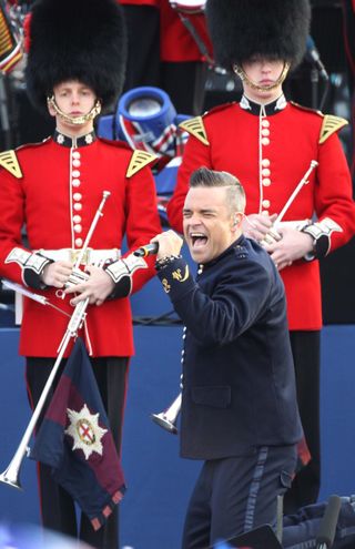 Robbie Williams singing in front of palace guards at the 2012 Diamond Jubilee concert