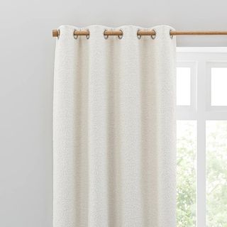 Dunelm Churchgate Woodhouse Boucle Eyelet Curtains hung on a wooden curtain pole