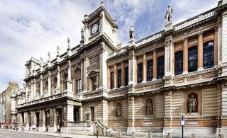Colour photograph of Pace Gallery, London - a long grand building with statues, pillars and a clock tower.