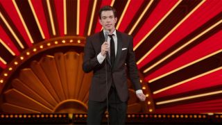 John Mulaney onstage with a cool backdrop in Kid Gorgeous At Radio City.