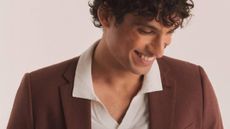 A male model wearing a burgundy suit from Jacamo.