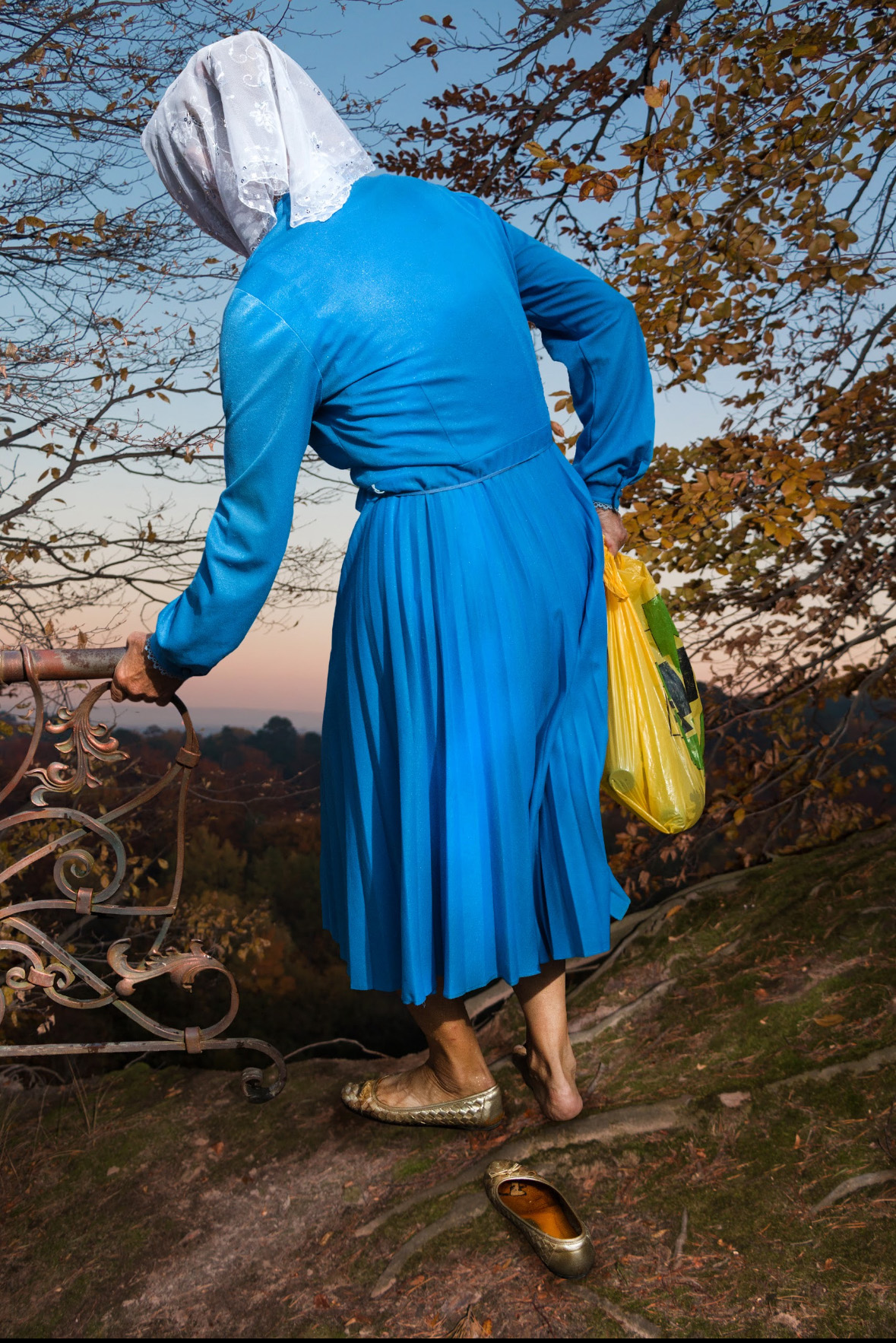 Woman in blue dress with white headscarf by Elena Subach