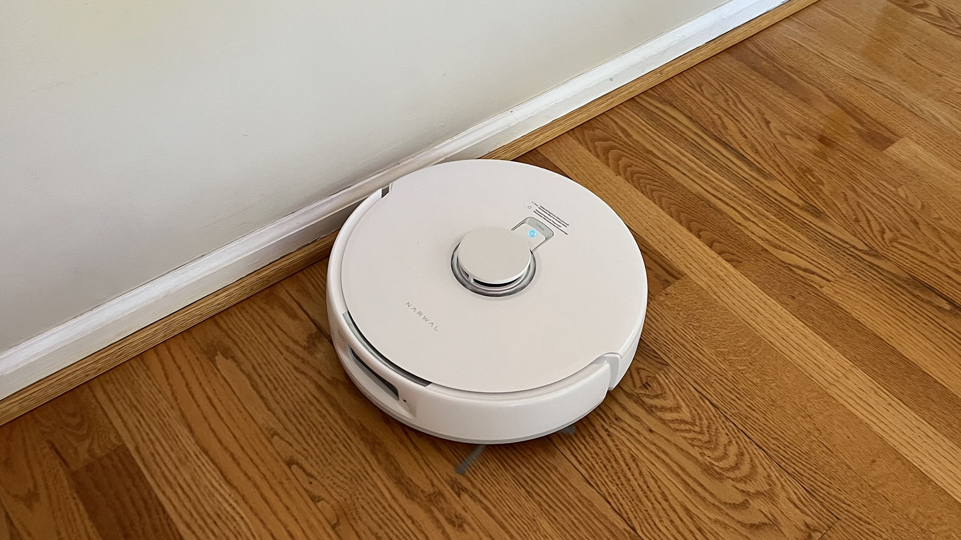 Narwal Freo X Plus robot vacuuming next to baseboards