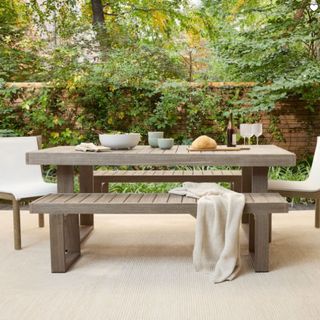 A wooden picnic-style outdoor dining table from West Elm