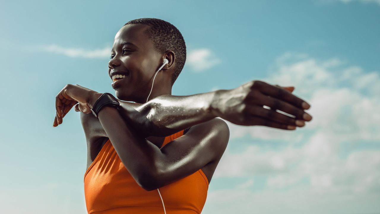 Woman stretching outside before a workout