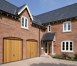 up and over canopy garage door with timber infill, style 2009 vertical in Golden Oak, Hörmann.