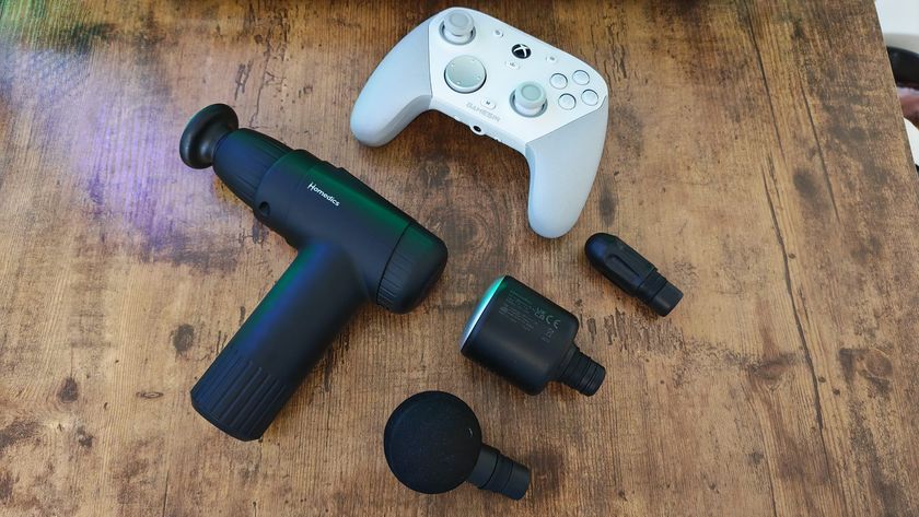 A Homedics massage gun next to a gaming controller