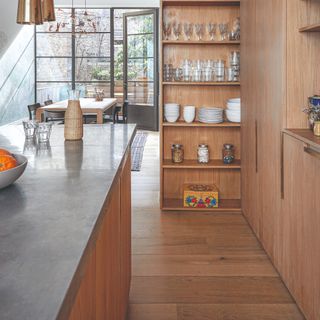 A natural wooden kitchen with wood floorboards and open shelving