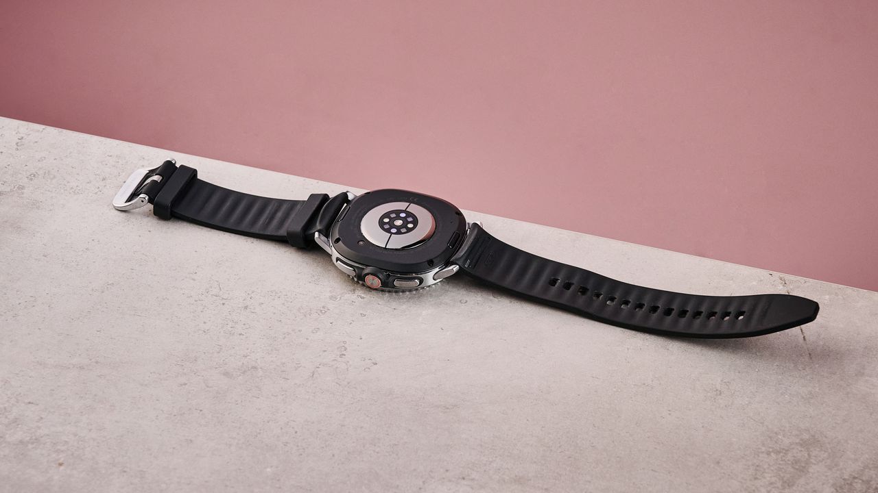 The Samsung Galaxy Watch 8 Classic lying flat on a table, showing the sensors on its underside.