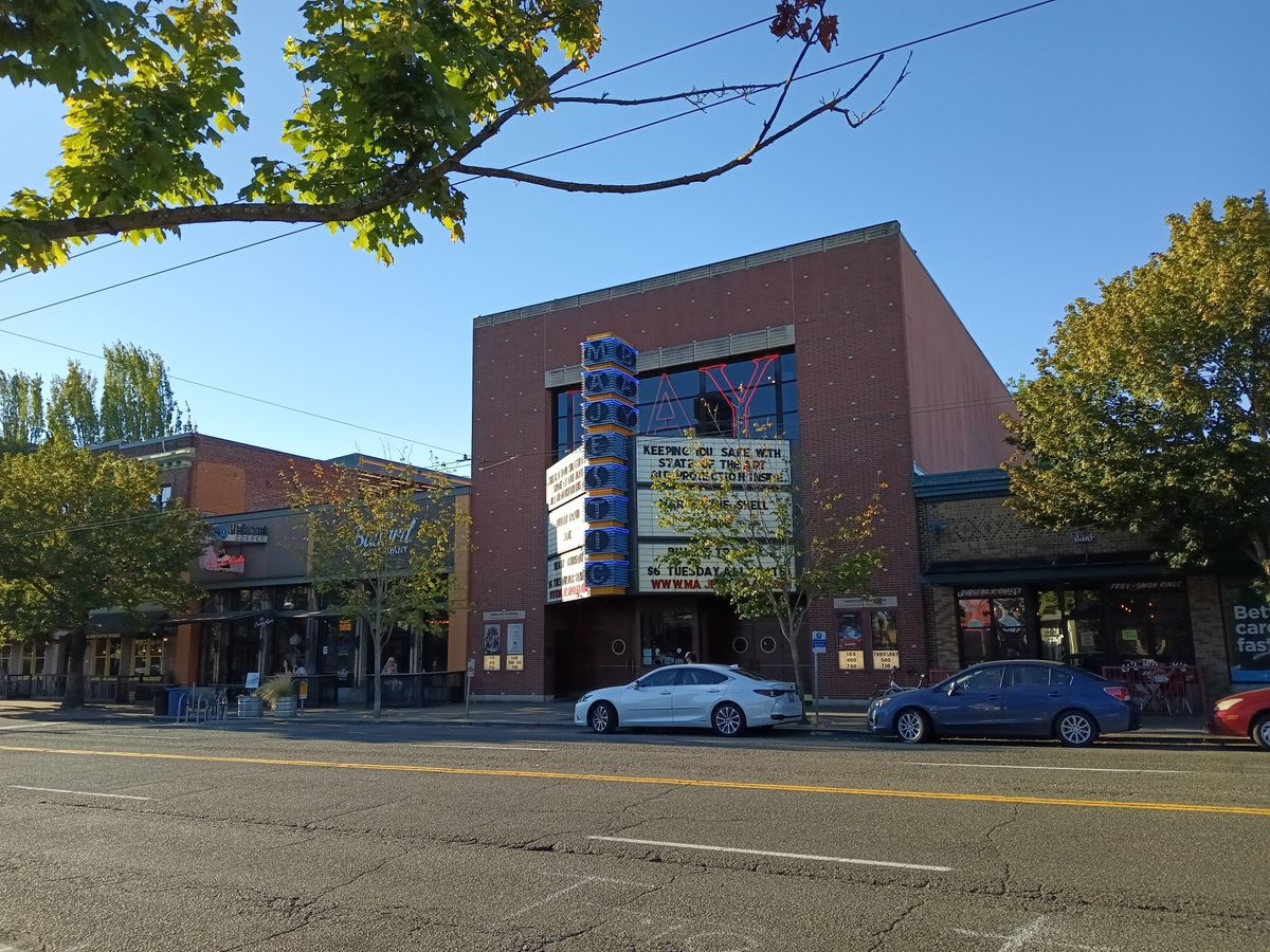 A movie theater entrance displaying titles now showing