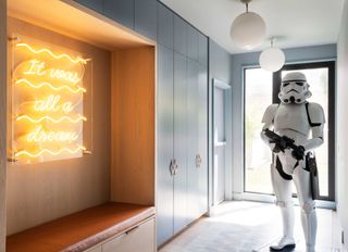 an entryway with a storm trooper and neon sign