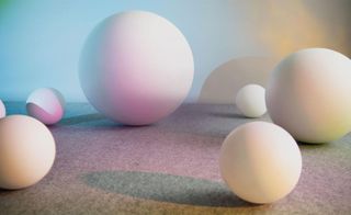 Multicoloured balls of varying sizes on a grey floor