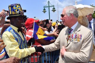 Prince Charles shaking hands with a man in Barbados on royal visit