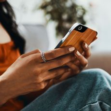A woman using one of the best mental health apps on her mobile phone