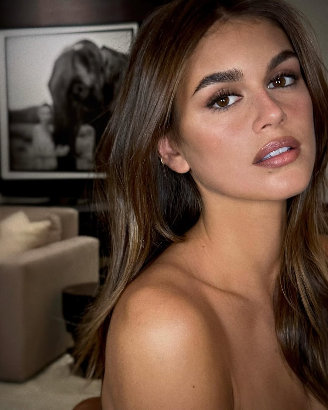 Kaia Gerber poses with glossy, ash brown hair.
