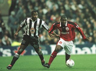 Des Lyttle of Forest goes past Les Ferdinand of Newcastle during the Nottingham Forest v Newcastle United FA Carling Premiership match at the City Ground in Nottingham, Great Britain.