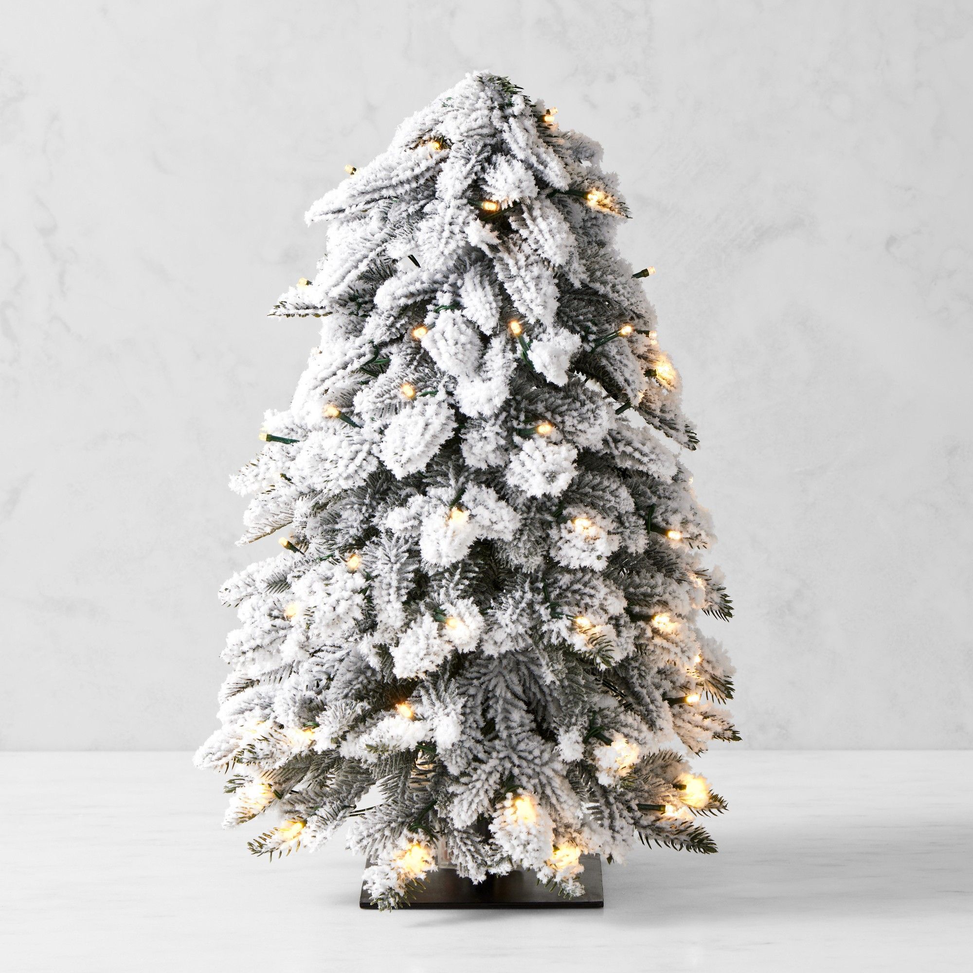 Frosted pre-lit mini tree with black base