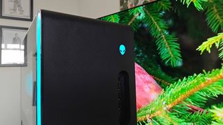 Close up of Alienware Aurora 2025 gaming PC with blue logo and side lights.