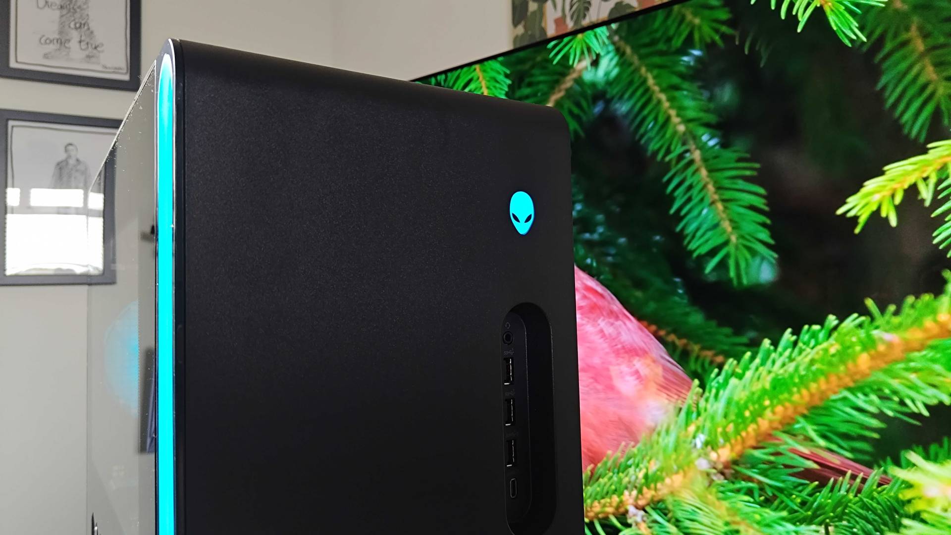 Close up of Alienware Aurora 2025 gaming PC with blue logo and side lights.