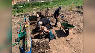 Archaeologists excavate a Neolithic tomb.