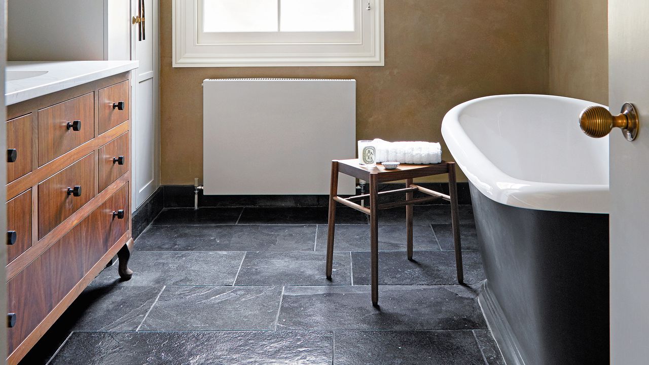 bathroom with tub and cabinet space