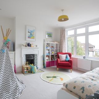 children's bedroom with white walls and red armchair