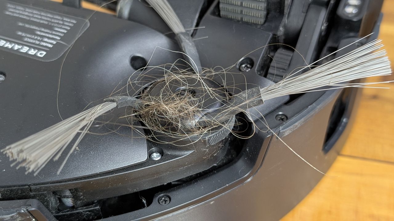 Dreame Matrix10 Ultra robovac close up of side brush with hair wrapped around it
