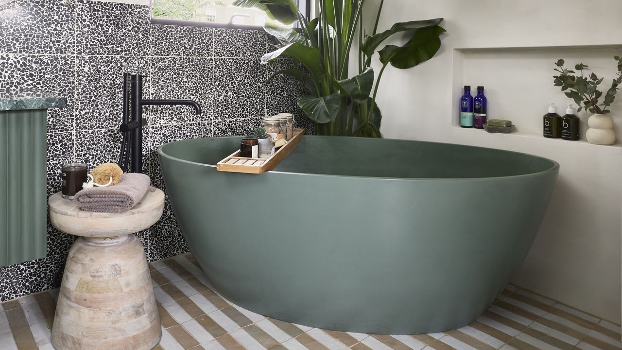 Bathroom with muted green matt freestanding bath.