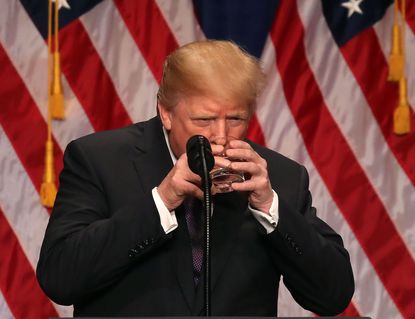 President Trump takes a drink