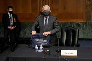 Anthony Fauci, director of the National Institute of Allergy and Infectious Diseases, departs following a Senate Health, Education, Labor, and Pensions Committee hearing in Washington, D.C., U.S., on Tuesday, May 11, 2021.