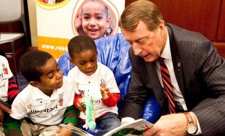 Bob Etheridge reads to a group of children.