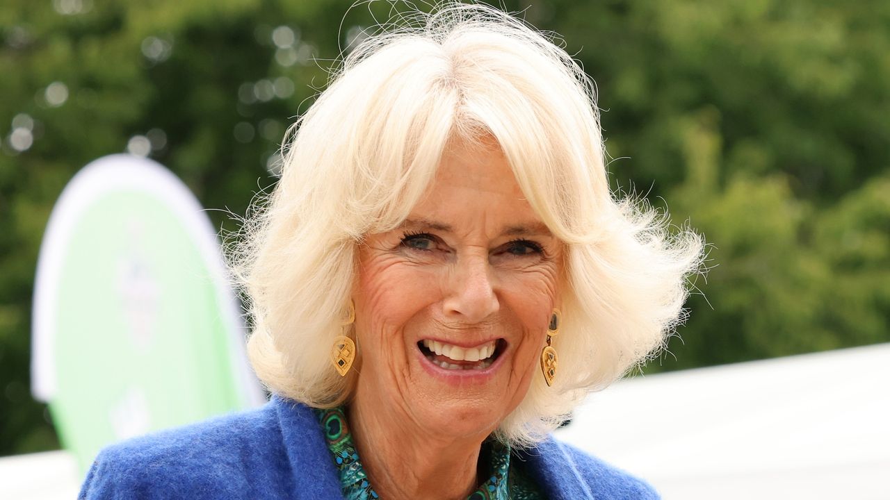 Queen Camilla&#039;s emerald shirt dress and blue shawl worn during a showcase of the Brecknock Agricultural Society’s annual show