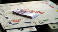500 Euro banknotes are on a Monopoly boardgame 