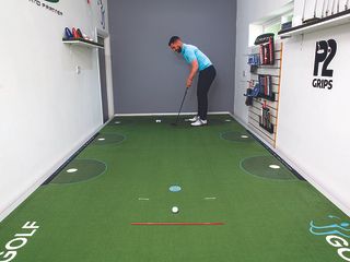 James Jankowski demonstrating a speed putting drill using alignment sticks