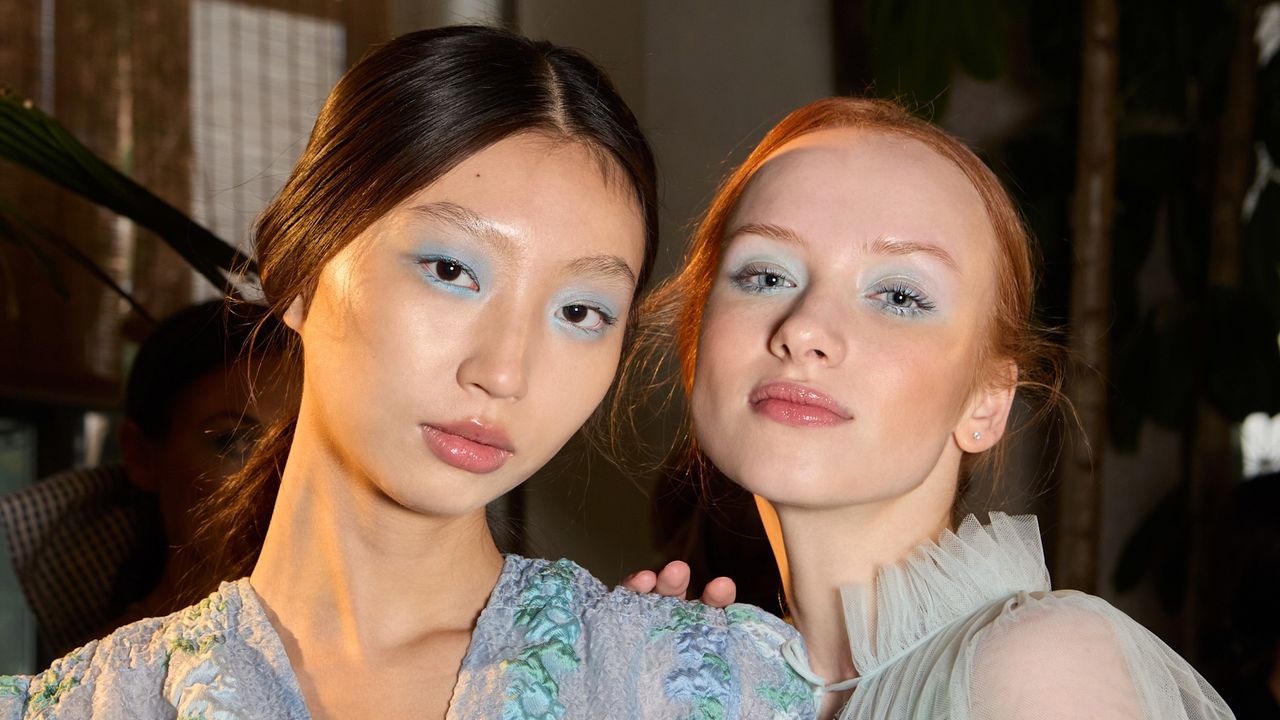 two models wearing blue eyeshadow with soap brows