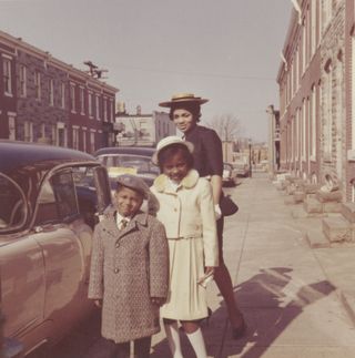 Archive photograph of Black woman and her family, dressed up to go out