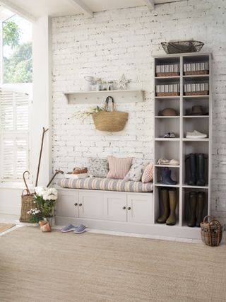 hallway storage showing bespoke painted unit with shoes and wellies in, bench to match