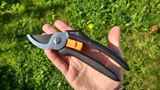Our reviewer holding the Fiskars P121, which is the UK equivalent to the P541 Bypass Pruner.