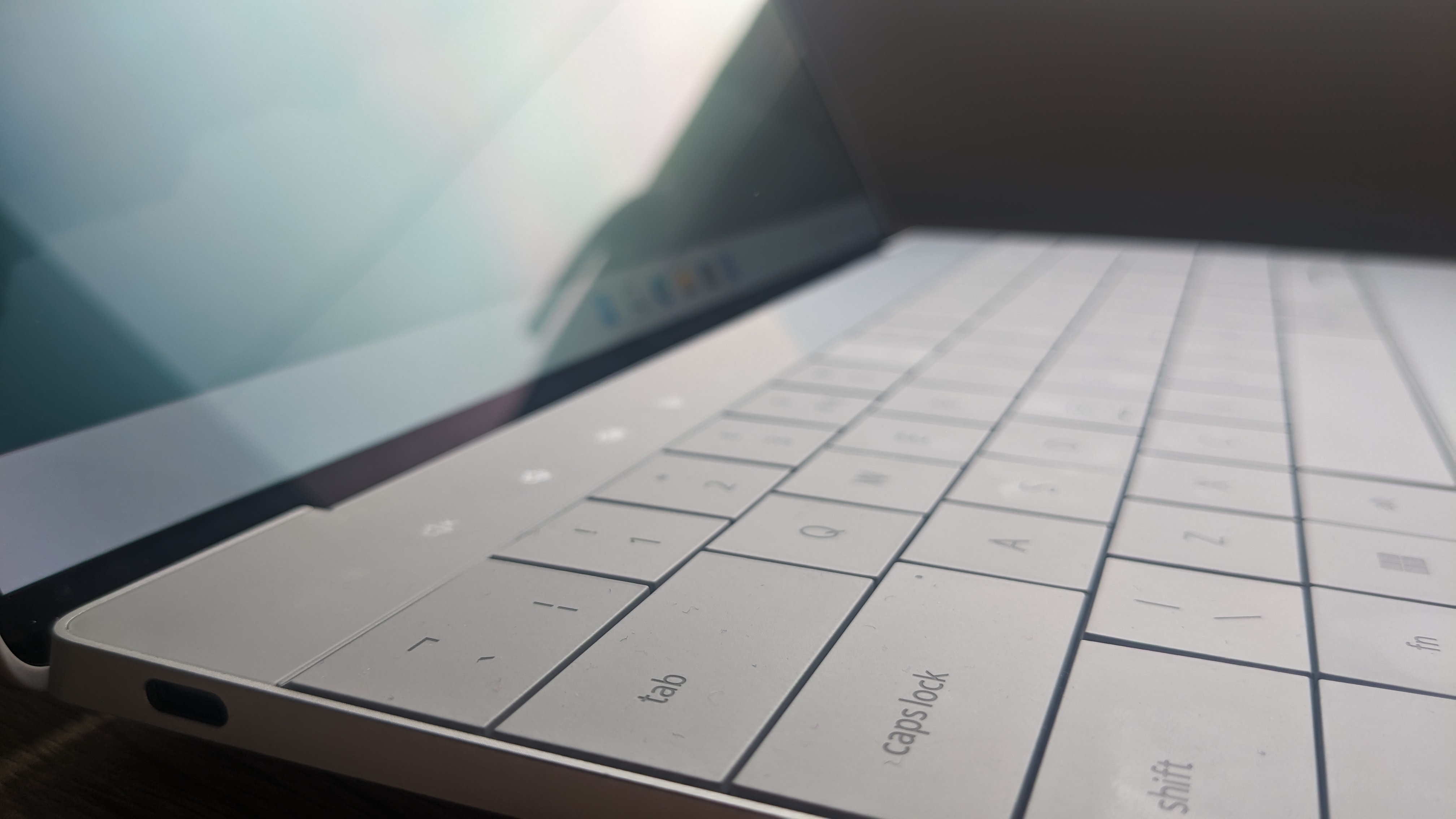 The Dell XPS 13 Plus photographed on a wooden desk.